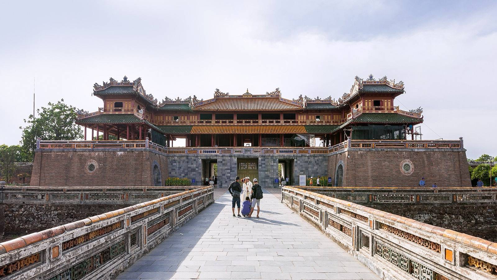 Ngo Mon, the main gate of Hue's Imperial City, seen along a stone bridge on a bright afternoon