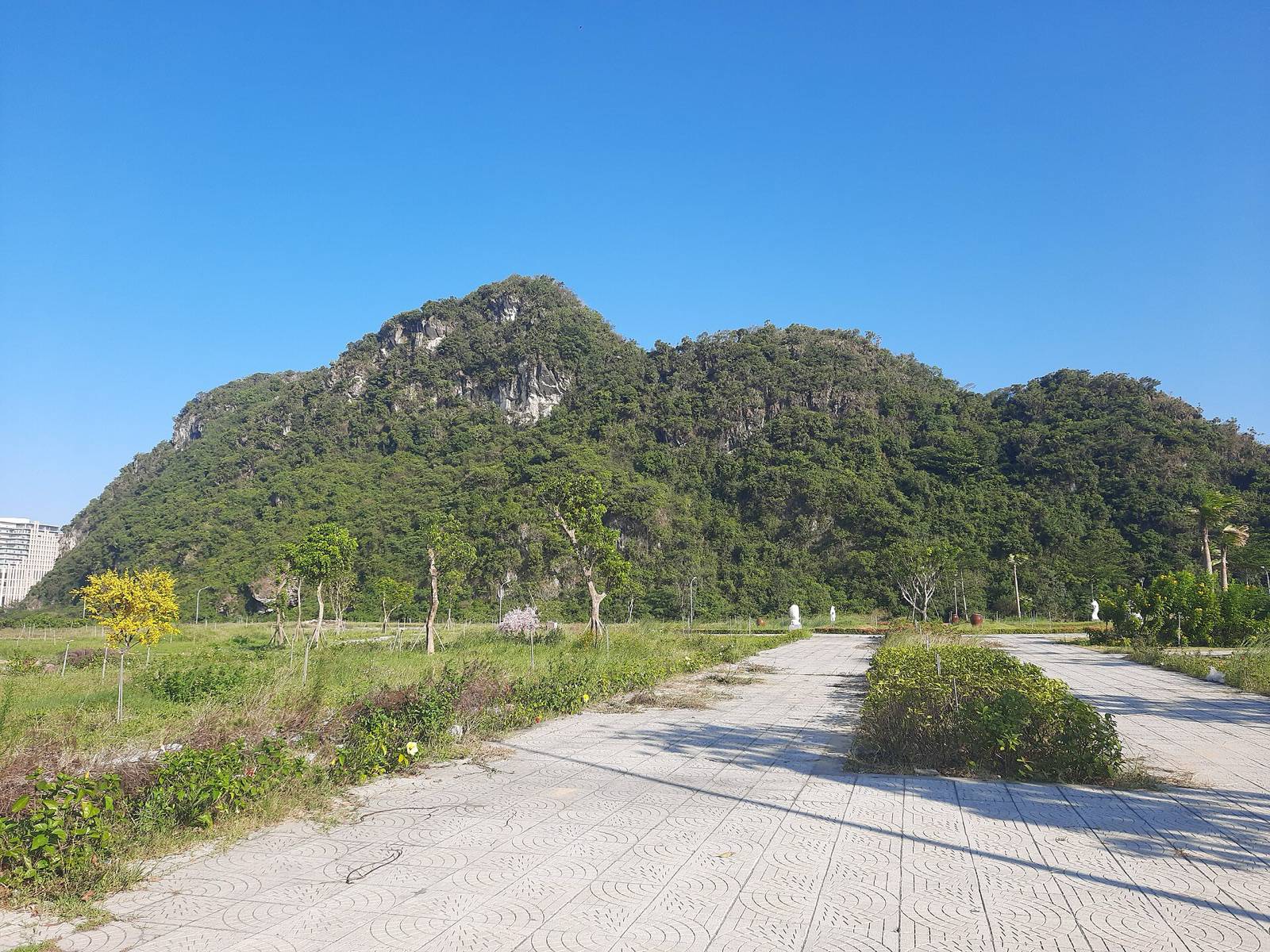Thuy Son, one of the five Marble Mountains, rising green and rocky under a clear blue sky in Da Nang